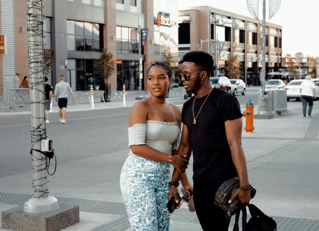 Tobi and Adaeze, a happy Nigerian couple, walking together on a street in Toronto